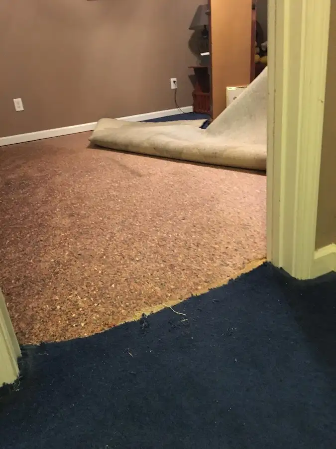 Carpet pad removal revealing water damage during Water Mitigation Services in San Dimas